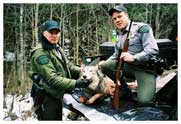 South of Crystal Falls, Iron County, November 15, 2006. COs Jason Wicklund (l) and Dave Painter (r) pose with 3 year old gray wolf illegally shot the day before. This photo was taken when we went to retrieve the animal for the evidence locker and immediately after getting a confession from the shooter.