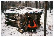 Deer season 2004, CO (now Sergeant) Steve Burton and I "took a little walk." This permanent blind is in Dickinson County, built of logs and tucked out in the bush. Steve is kneeling to talk to the hunter inside. After a lot of evasions and lies, the man confessed to shooting a seven-point buck without a license. We ended up going to the camp and confiscating the deer. Major Steve Burton of the Michigan National Guard is now in Iraq with his combat engineer outfit, clearing routes in Baghdad. You might want to throw a prayer his way once in awhile.